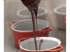Chocolate is being poured into the cake mold before being put into the oven.